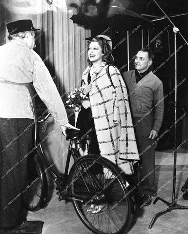 director W S Van Dyke or Roy Del Ruth, Jeanette MacDonald rides her bike to work - 1942 film I Married an Angel - 0452-025