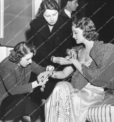 Jeanette MacDonald getting jewelry fitted behind the scenes - 1939 film Broadway Serenade - 0456-023