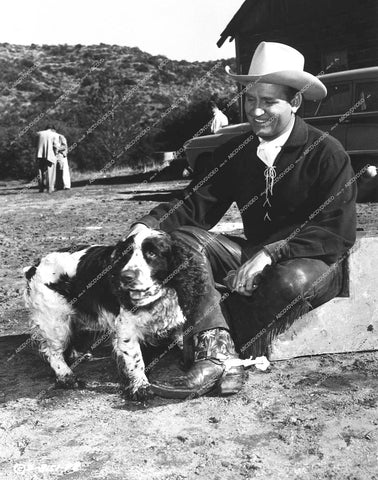 Gene Autry relaxing with his dog on location - 1953 film Saginaw Trail - 0459-002