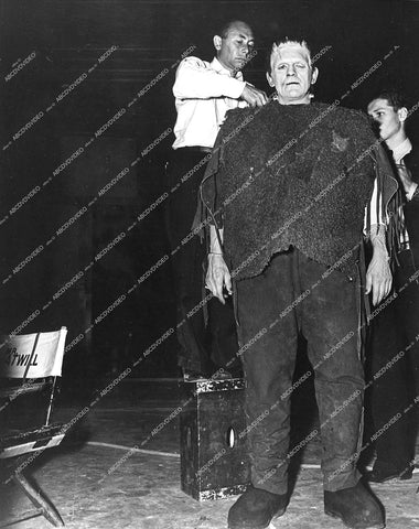 Boris Karloff gets wardrobe adjustments behind the scenes on set - 1939 film Son of Frankenstein - 0460-021