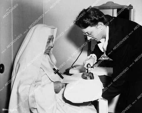 candid Dame May Whitty gets her nun's habit ironed between scenes - 11007-035