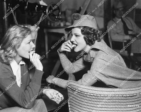 candid Elissa Landi and friend eating peanuts between the scenes film Mad Holiday - 11011-006
