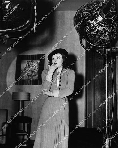 candid Margaret Lindsay standing among the klieg lights - 11012-008