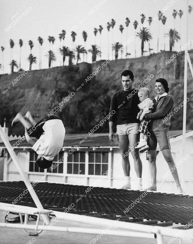 candid Jeffrey Hunter & wife Joan Bartlett w kids on trampolene in backyard - 11028-018