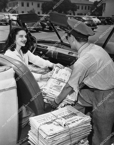 candid Marjorie Riordan helps deliver the newspaper - 11030-008