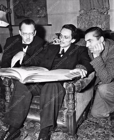 candid Manly Hall Earl Ingsberg Bela Lugosi looking at very large book 337-08