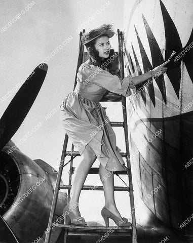 Yvonne De Carlo helps the war effort painting shark mouth on WWII airplane 10771-29