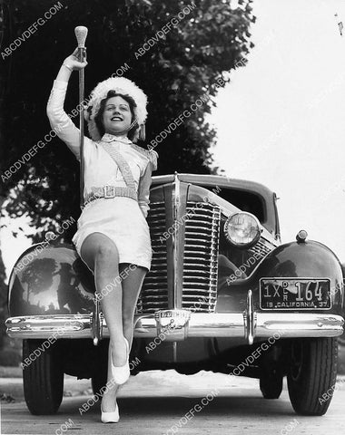 cute marching band member in front of new 1937 Buick automobile 1319-09