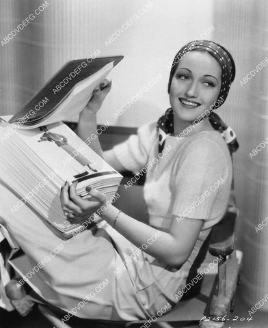 Dorothy Lamour looking at the studio keybook of her pics 1518-18