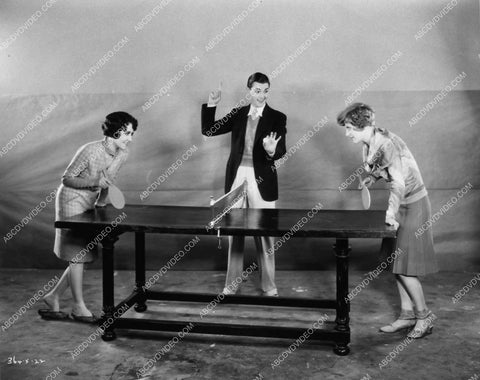 Eddie Nugent referees a ping pong challenge between Dorothy Sebastian & Joan Crawford 1564-08