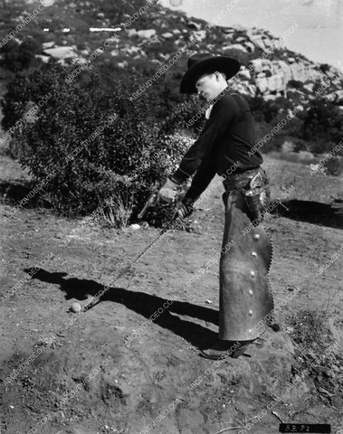 cowboy star Bob Baker is getting a little frustrated w his golf swing, takes other measures 1595-26