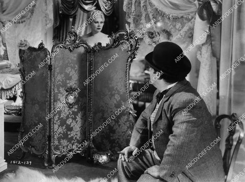 Mae West getting dressed behind the partition 1895-27