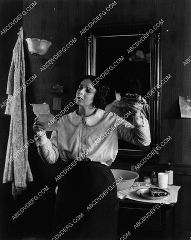 Colleen Moore reading a letter and eating a piece of pie 1939-35