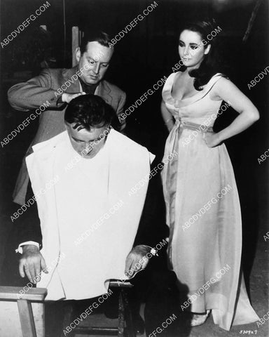 candid Elizabeth Taylor watches Richard Burton get final makeup touches 1974-37
