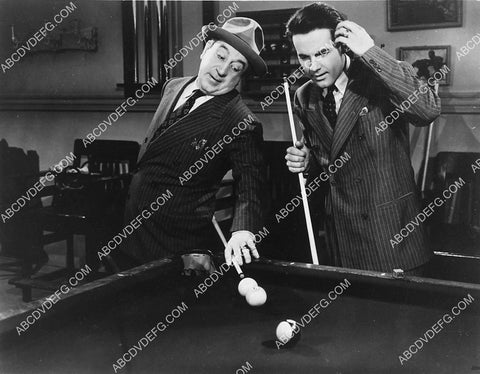 Hugh Herbert shows Johnny Downs cool trick shot on the pool table 2169-18