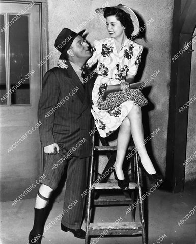 Kay Kyser showing his garters to Shirley O'Hara on set film Around the World 2250-31