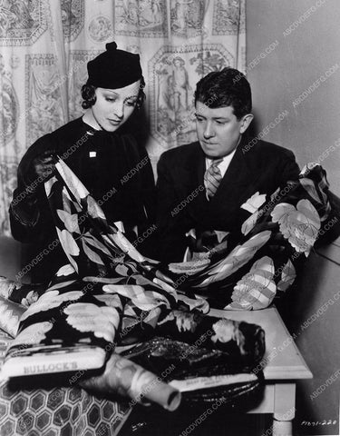 candid Frances Drake checking out bolts of fabric 2957-04