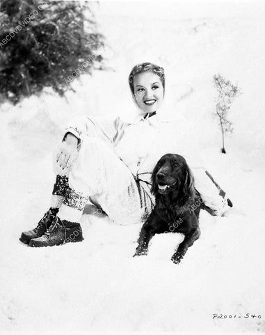 Betty Grable plays w her dog in the snow 3030-24