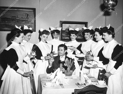 John Hodiak and all the Harvey Girls take a break between filming The Harvey Girls 3308-35