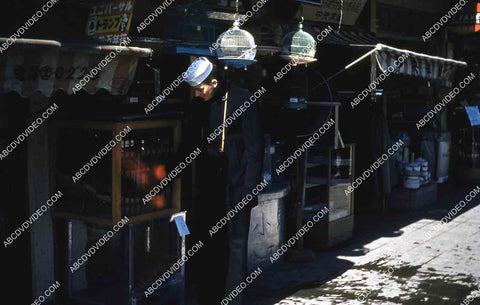 circa 1956 historic Philippines city life U.S. sailor checks out local shops 35m-16297