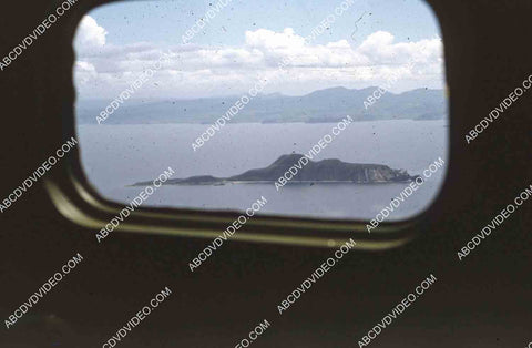 circa 1956 U.S. sailor tours historic Philippines from air in twin engine air force plane 35m-16411
