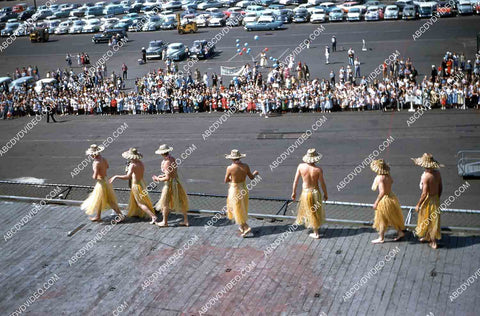 circa 1956 historic San Diego aircraft carrier USS Shangri-La arrives w sailors in grass skirts 35m-16597