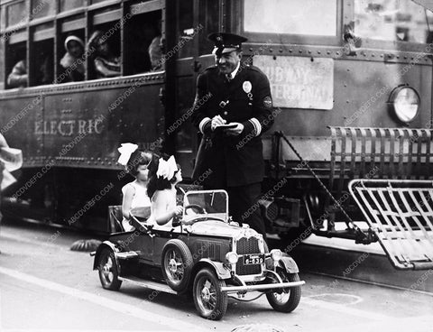 2 cute little girls in their minature car getting speeding ticket 3629-36