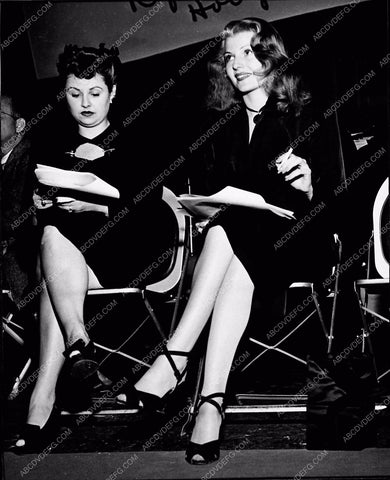 Rita Hayworth going over the script behind the scenes 3643-09