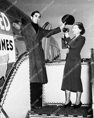 cool news photo stewardess takes picture of Tyrone Power as gets off the airplane 3723-09