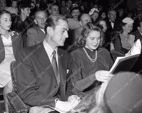 Ingrid Bergman looking at her program guide 45bx05-56