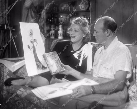 Mary Pickford going over costume wardrobe sketches 45bx07-019
