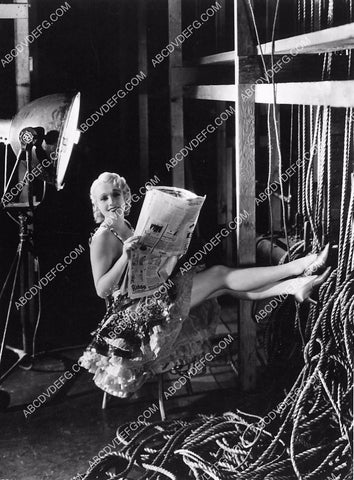 candid Anita Page kicks up her legs and reads the newspaper 6103-02