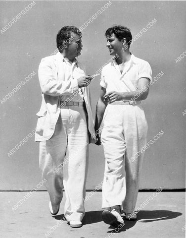 Jean Hersholt & Robert Taylor head for the tennis court 6630-01