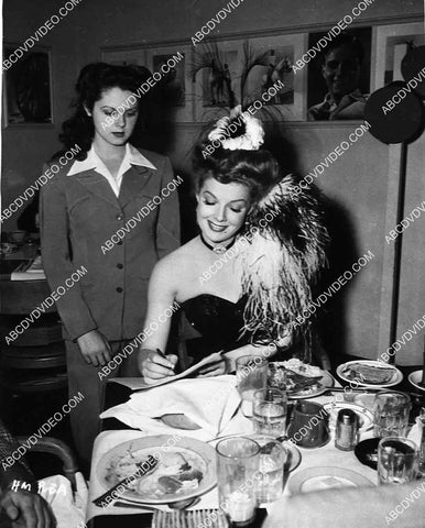 candid Ann Sheridan signs an autograph for a fan 8213-31