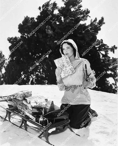 Maureen O'Sullivan treking her Christmas present delivery through the snow 8245-17