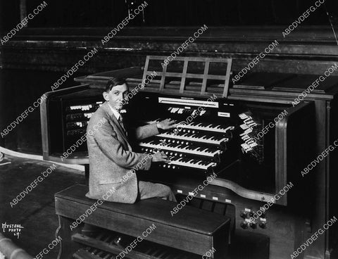 music composer Charles Cadman sitting at giant pipe organ 8668-23