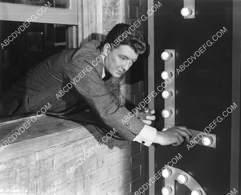 Fred Brady changing the light bulbs on the marquee film Meet Me on Broadway 8B11-315