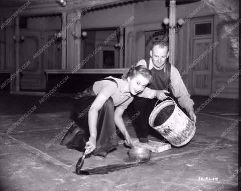 Ida Lupino helps crew member get set ready One Rainy Afternoon 8b4-392
