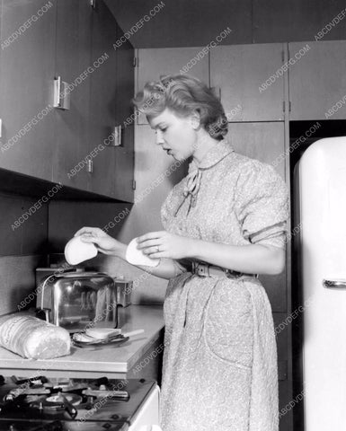 candid Anne Francis makes some toast behind scenes MGM 8b6-447