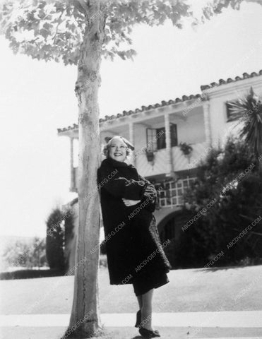 Sonja Henie leaning against a tree 9021-02