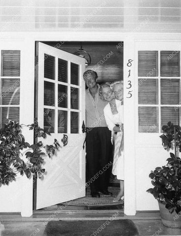 candid Richard Denning w wife and daughter looking out the front door 9102-19