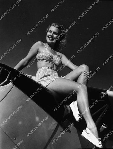 pinup pose Brenda Joyce sitting on an airplane 9223-27