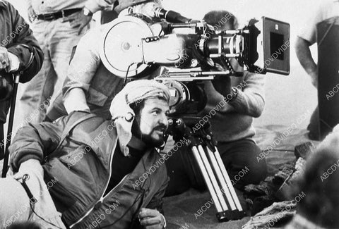 John Milius down in the dirt directing a film 9264-14