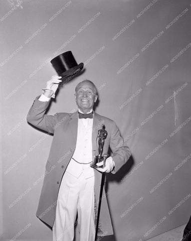 1958 Oscars Maurice Chevalier and statue Academy Awards aa1958-16</br>Los Angeles Newspaper press pit reprints from original 4x5 negatives for Academy Awards.