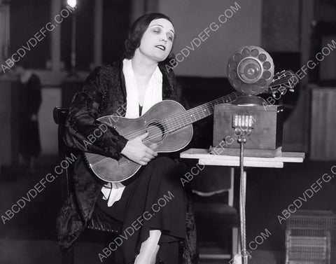 silent star Pola Negri strums the guitar and listens to the radio 8b20-0763