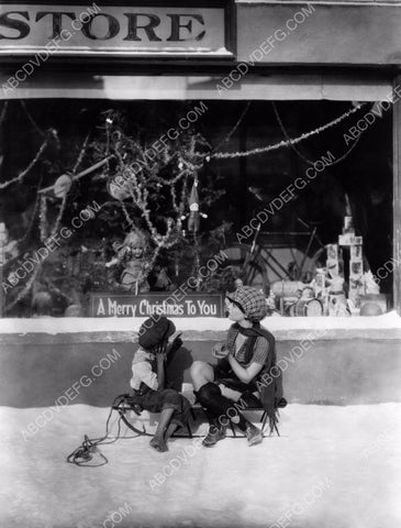 Dorothy Sebastian on snow sled store front Christmas display 8b20-0898