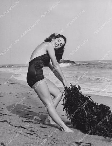 Elizabeth Taylor battling a wod of seaweed on the beach 8b20-1031