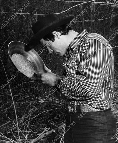 Clint Walker inspecting his gold pan 8b20-10696