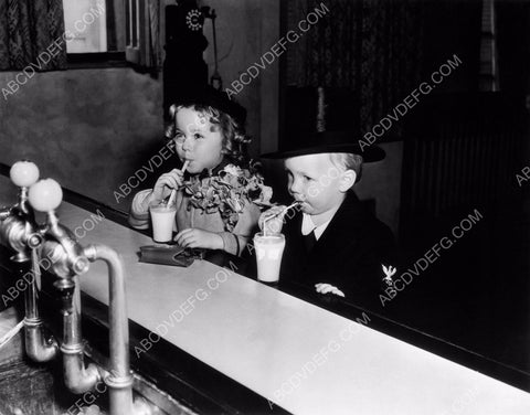 Shirley Temple and friend enjoy a milk shake 8b20-1088