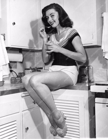 Elaine Stewart cute in shorts sitting on kitchen counter eating a snack 8b20-12024